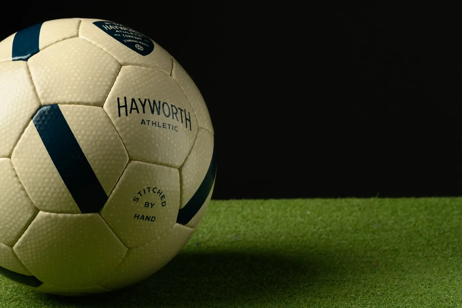 The No. 152 on turf, its Stitched by Hand panel turned to the light.