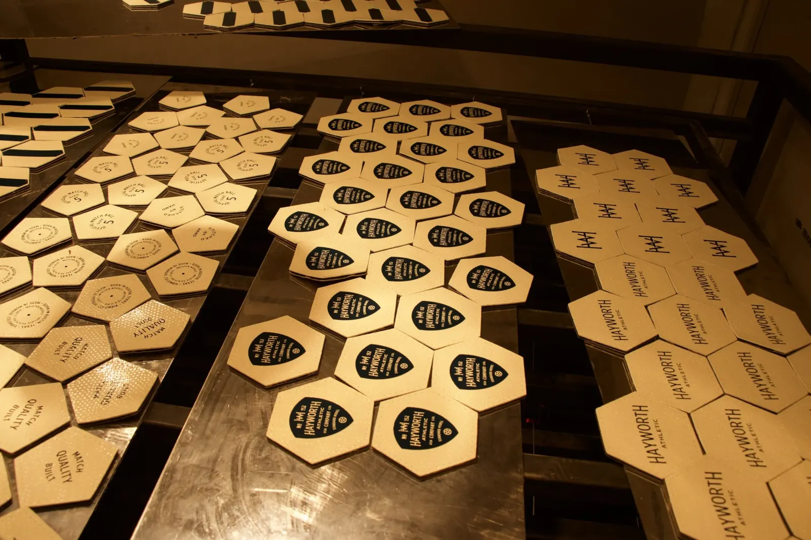 Cut hexagon and pentagon panels laid out on a workshop table.